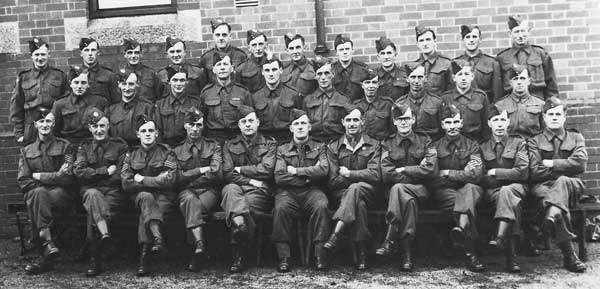 Above Launceston Homeguard in 1945. Back row, extreme right, W.S. Cottle. Middle row, 5th from left, W.H.(Bill) Jones, agricultural engineer and blacksmith. Front row, 5th from right, W.T.(Bill) Gynn, postman and part-time farmer. Photo courtesy of Chris Gynn.