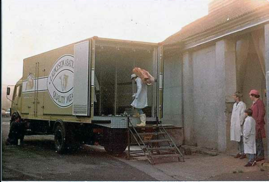Above Launceston abattoir lorry loading at the abattoir with Roy Burnley playing with the battery Pete Lang, Steve Roberts in the lorry, Simon Matthews going up the steps, in red Martyn Andrew, and young Pearce , the Bosses son. Photo by Geoff Pearce.