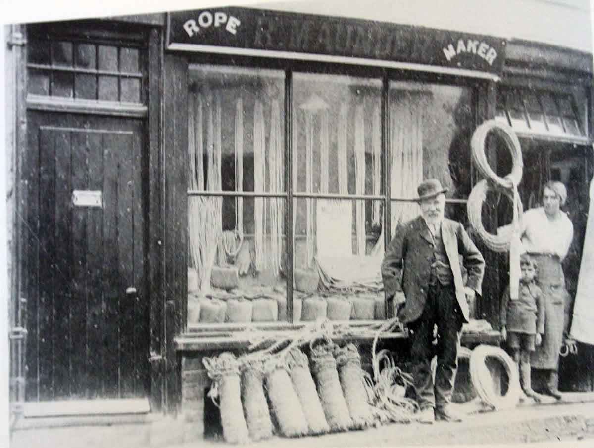 'Happy' Joe Maunder stands outside the Race Hill shop with his grandson Bill looking on with his mother, Jessie .