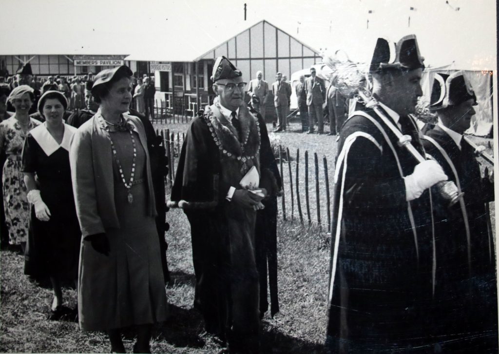 Cecil Robins is led to the opening speech at the 1955 Bath and West Show