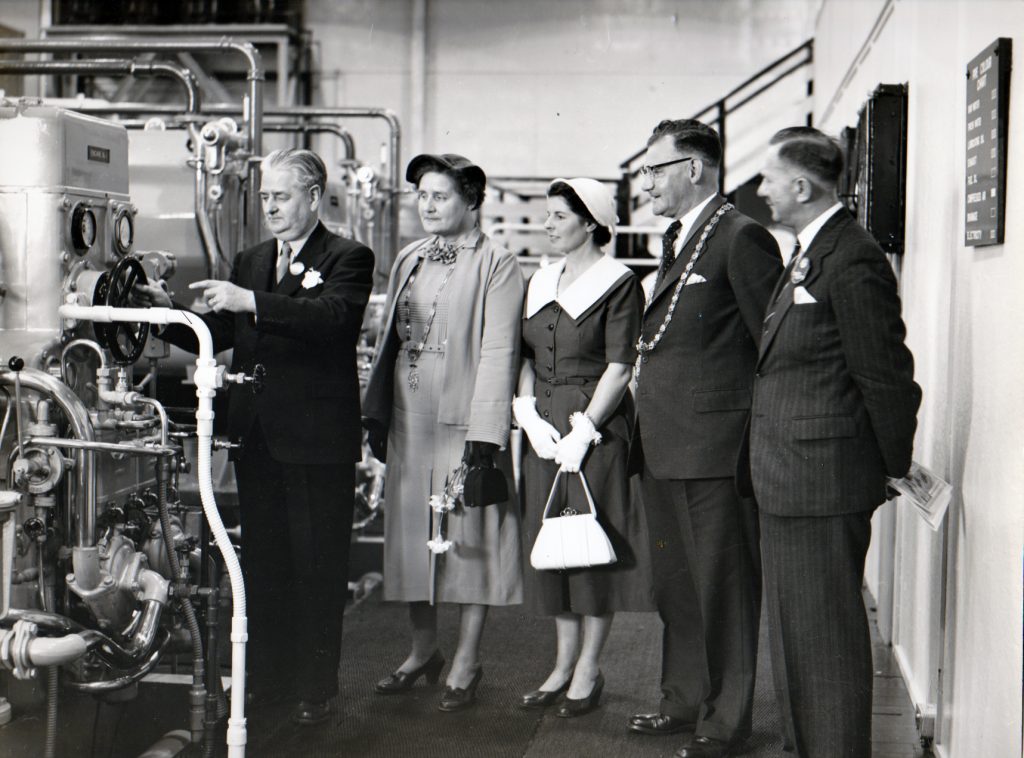 Cecil Robins is shown the power station for the 1955 Bath and West Show at Launceston