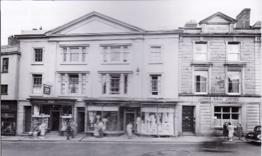 Hicks and Son alongside Lloyds Bank in Broad Street, Launceston in the 1960's.