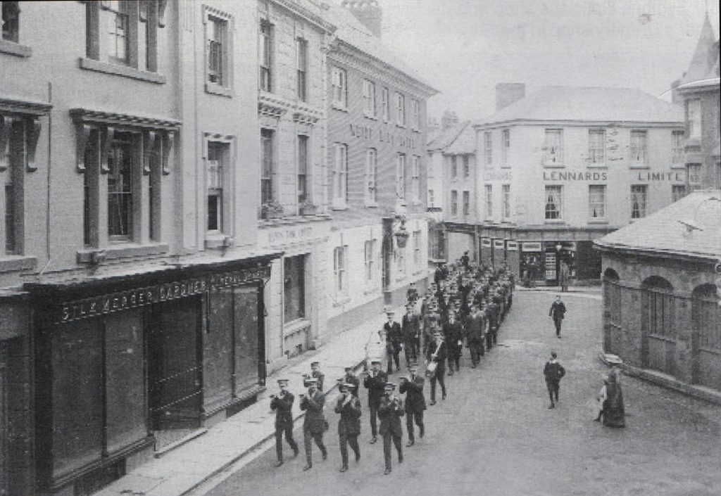 Launceston Town Band lead up a procession through the Square c.1920.