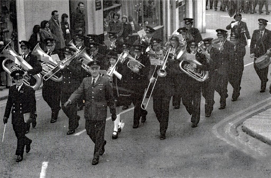 Launceston Town Band leading the parade during a remembrance day ceremony in the 1970's. Being led by Wing Commander Robinson and bandmaster Ben Luxton.