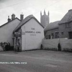 Arundell Arms car park in 1951 with Ian Murrain sitting on the wall. Photo courtesy of Gary Lashbrook.