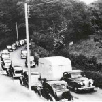 The A30 in the 1950's with a queue of vehicles winding their way up past Edymede House, Launceston.