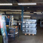 Peter Dingle packing ladders at Abru, Launceston. Photo courtesy of David Gomm.