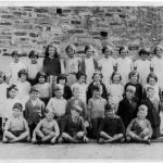 National School in the late 1930s
Front row from left: Billy Uren, Charlie Sandercock, unsure, unsure, Bernard Desico, Robin Lampey, Kenneth May
Second row: Walter Smith, Charlie Cottle, Norman Hawkin, Fernley Branch, Peter Huxtable, Frank Furse, Derek Gerry, John Jury, Tom Trewin
Third row: Ruben Rickard, - - - Logg, unsure, unsure, Vera Currah, unsure, Joan Coleman, unsure, unsure, unsure, unsure, Peter Jury
Back row: Donald Farrel, Lucy Stoneman, Ida Cox, Phyllis Sandercock, unsure, Barbara Pike, Lorna Bradford, Lucy Kerslake, Joan Adams, Josephine Bickle, Barbara Hamlyn, John Hockin. Photo courtesy of John Jury. National School in the late 1930s. Photo courtesy of John Jury