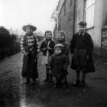 Photo taken on the Walk, Launceston, just off Tower Street. The two boys on the outside are Doug Bridgeman on the right, John (Paddy) Maguire on the left in the bold check shirt, Moira is at the front and Ann Bridgeman and Tarry Barriball are the two standing behind in the middle. Photo courtesy of Tarry Barriball.